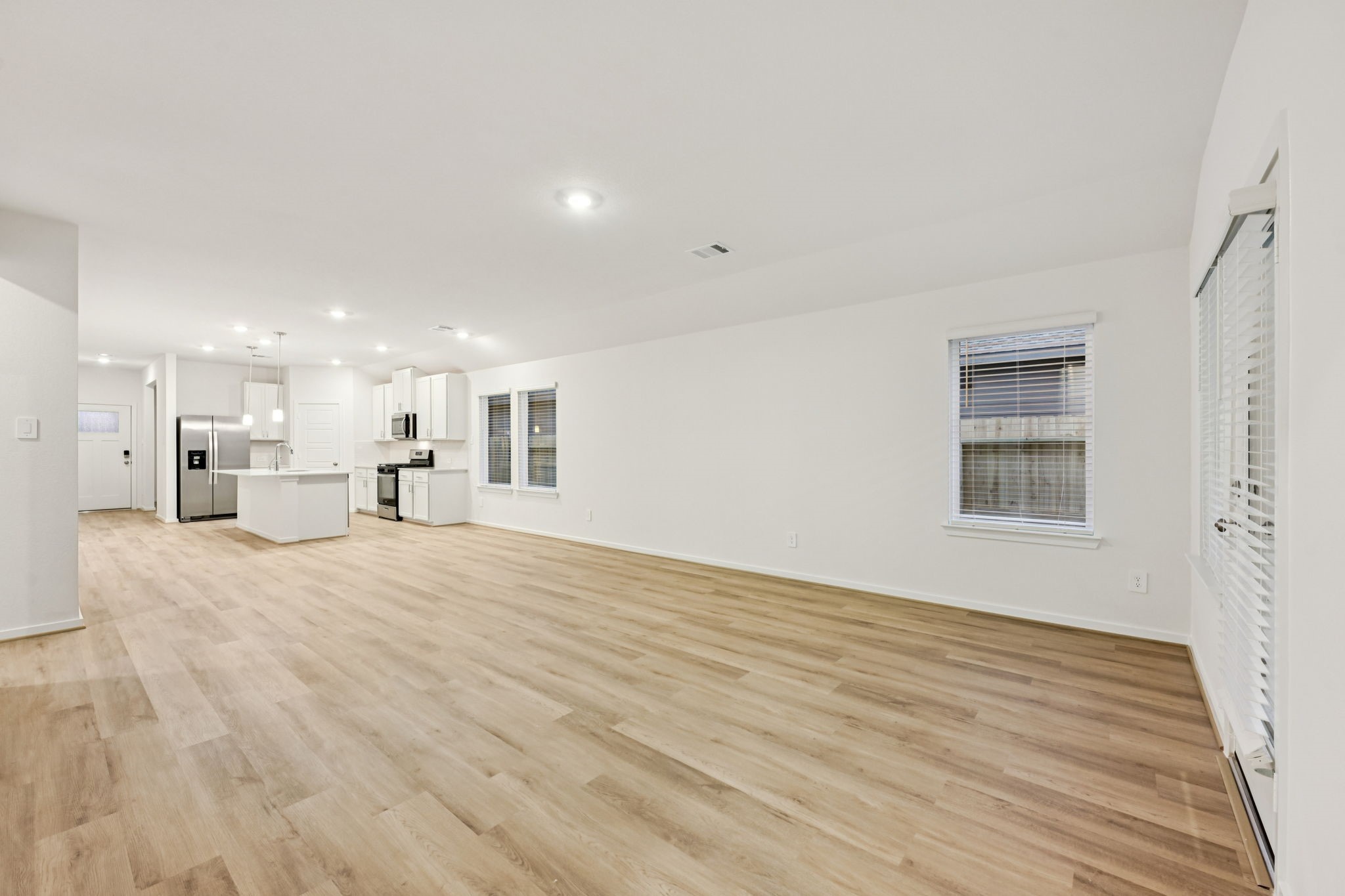 16213 Parish Pointe Court Conroe, TX 77302 - Photo 7 of 32 a view of kitchen and empty room with wooden floor