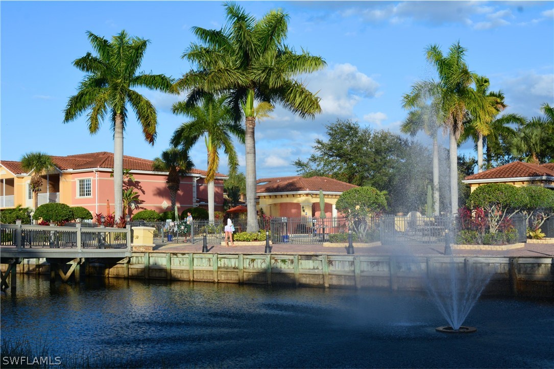 20121 Estero Gardens Circle, Unit 101 Estero, FL 33928 - Photo 1 of 24 a view of swimming pool with outdoor seating and house in the background