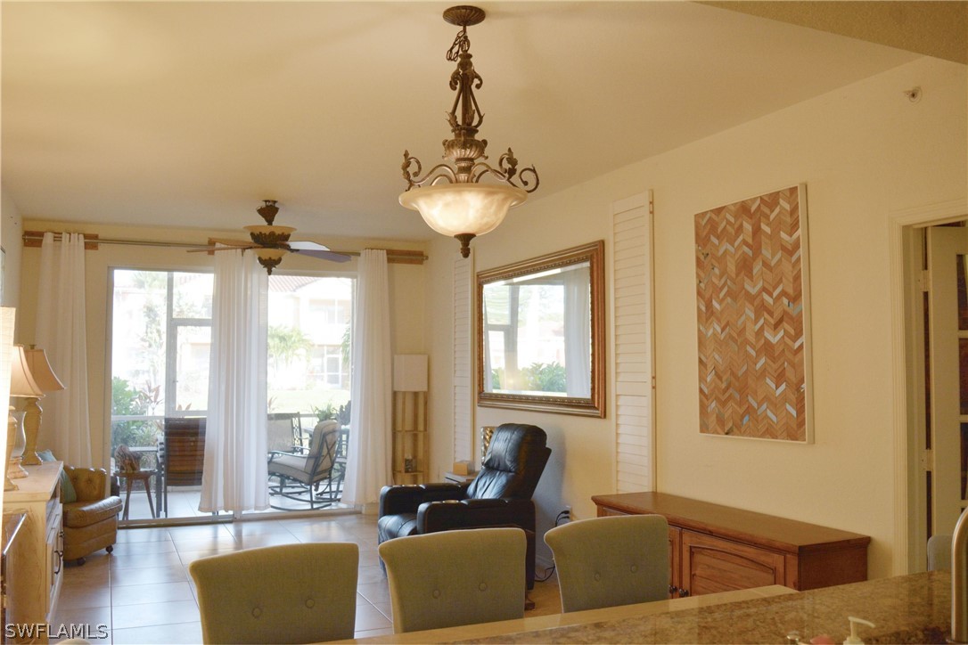 20121 Estero Gardens Circle, Unit 101 Estero, FL 33928 - Photo 12 of 24 a living room with furniture and a chandelier