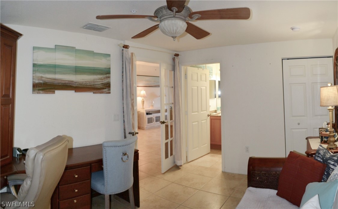20121 Estero Gardens Circle, Unit 101 Estero, FL 33928 - Photo 13 of 24 a view of a livingroom with furniture and a chandelier fan