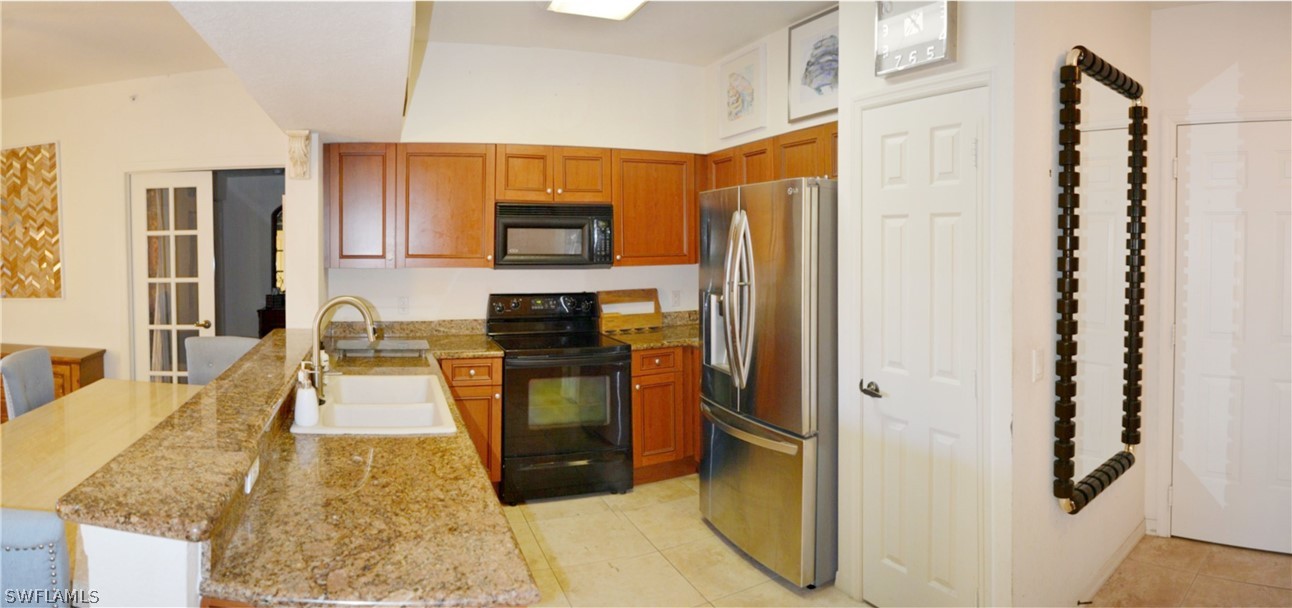 20121 Estero Gardens Circle, Unit 101 Estero, FL 33928 - Photo 18 of 24 a living room with stainless steel appliances kitchen island granite countertop furniture a rug and a window