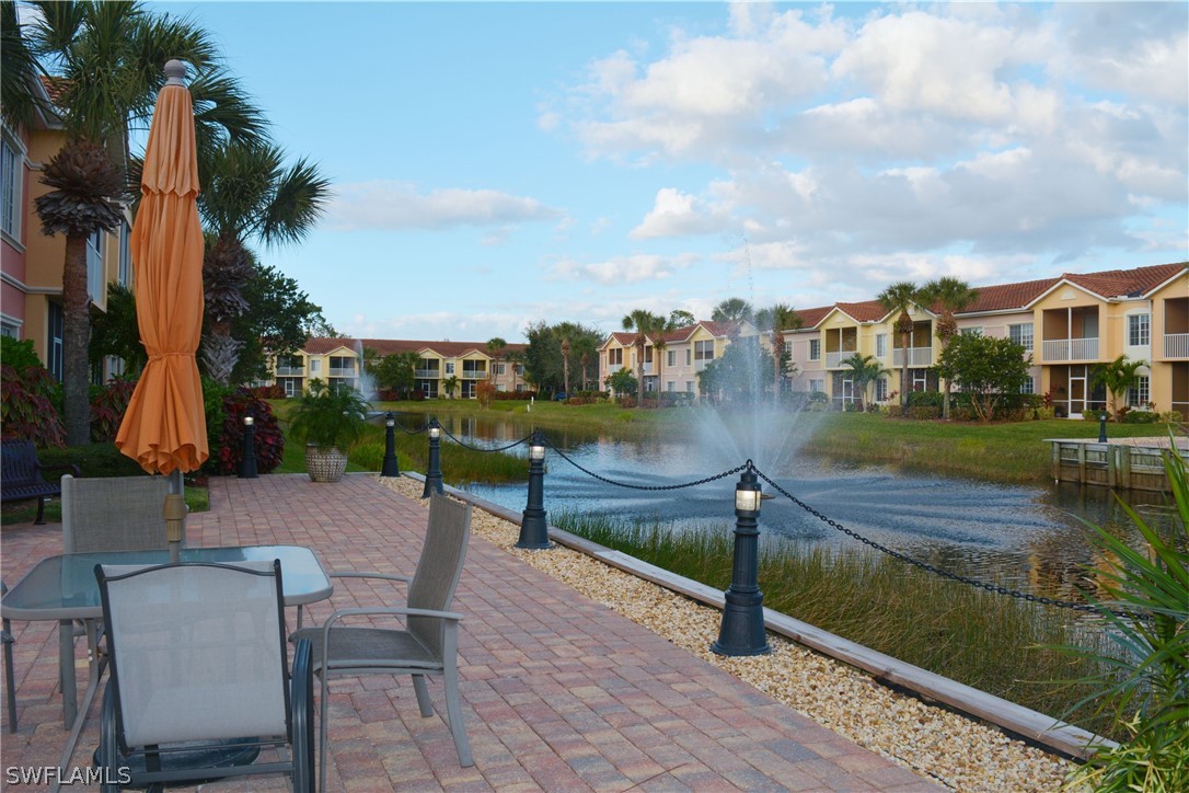20121 Estero Gardens Circle, Unit 101 Estero, FL 33928 - Photo 21 of 24 a view of a lake with couches and city view