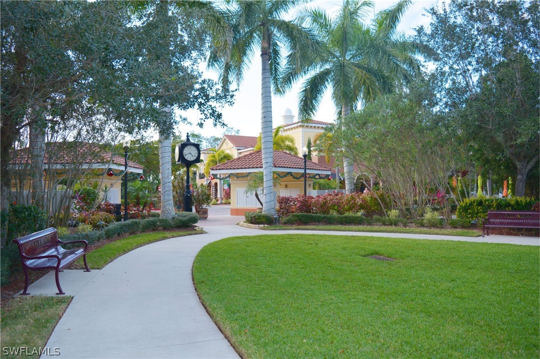 20121 Estero Gardens Circle, Unit 101 Estero, FL 33928 - Photo 23 of 24 a view of a park with bench and trees