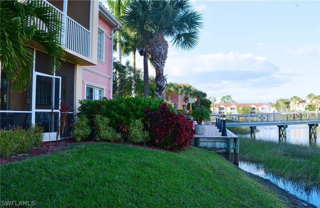 20121 Estero Gardens Circle, Unit 101 Estero, FL 33928 - Photo 5 of 24 a view of a house with a yard and potted plants