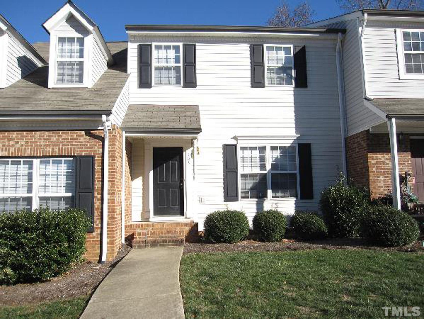 101 Rock Haven Road, Unit A103 Carrboro, NC 27510 - Photo 1 of 17 a view of a brick house with a yard plants and large tree