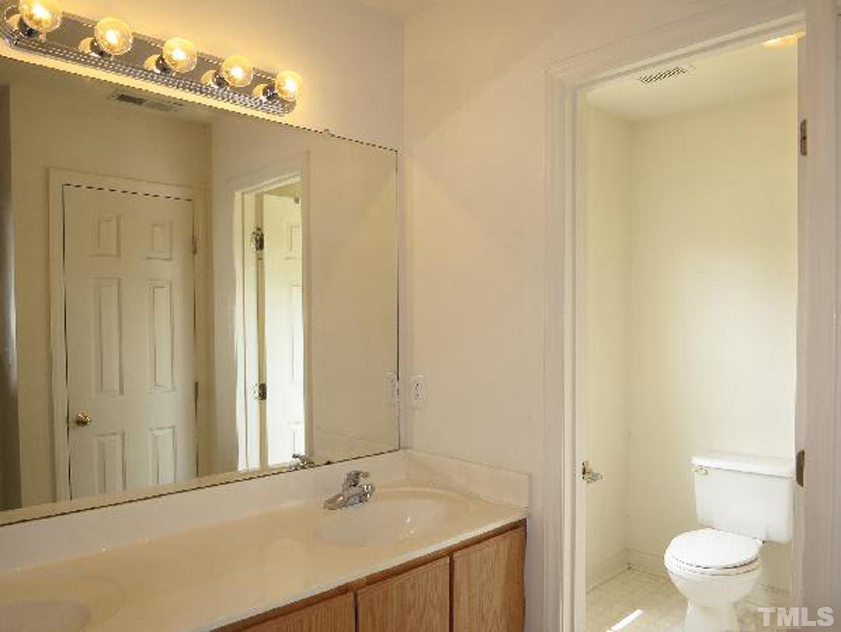 101 Rock Haven Road, Unit A103 Carrboro, NC 27510 - Photo 12 of 17 a bathroom with a sink and a mirror
