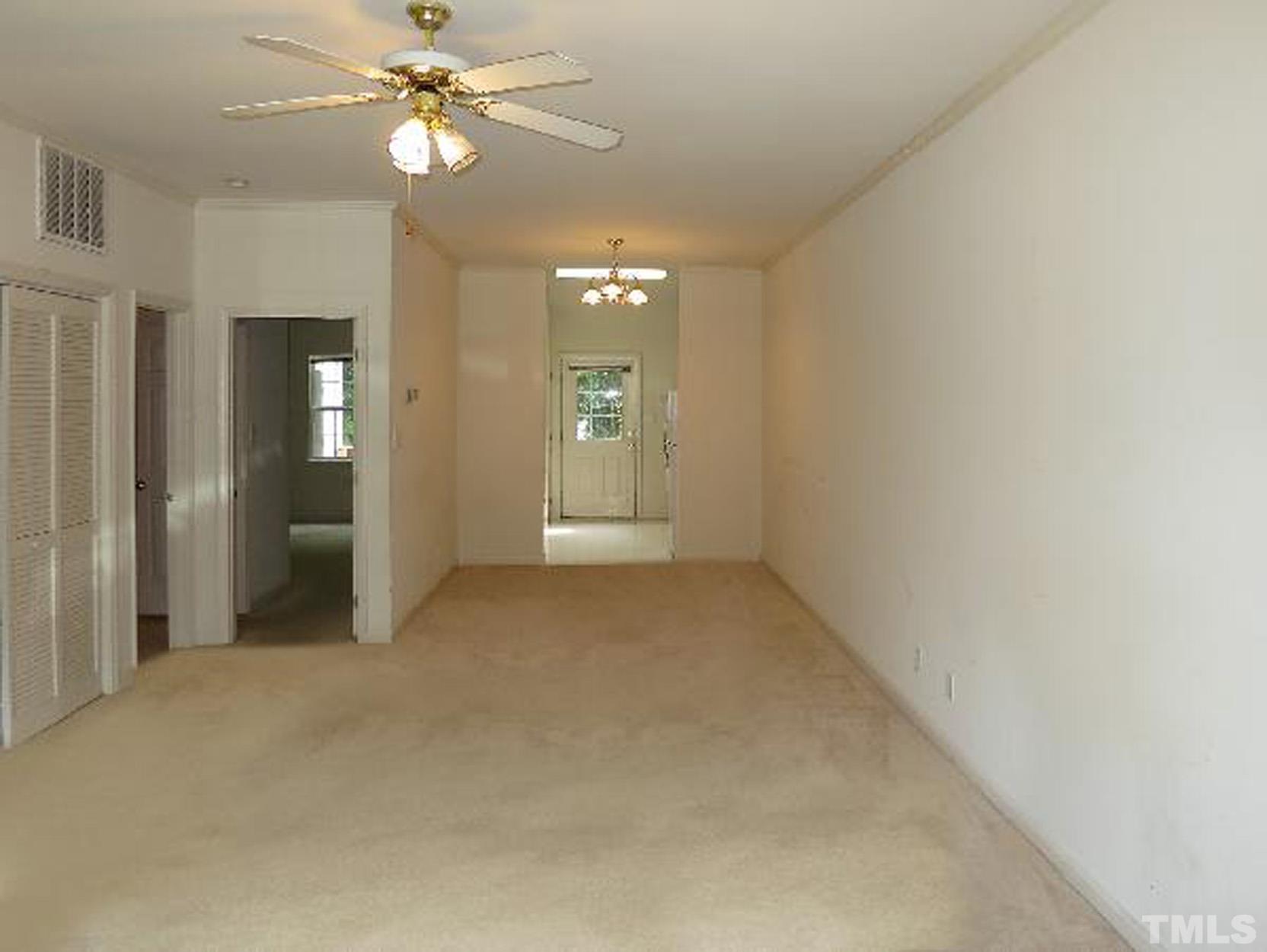 101 Rock Haven Road, Unit A103 Carrboro, NC 27510 - Photo 4 of 17 an empty room with fan and entrance
