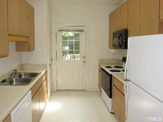 a kitchen that has a sink and a stove