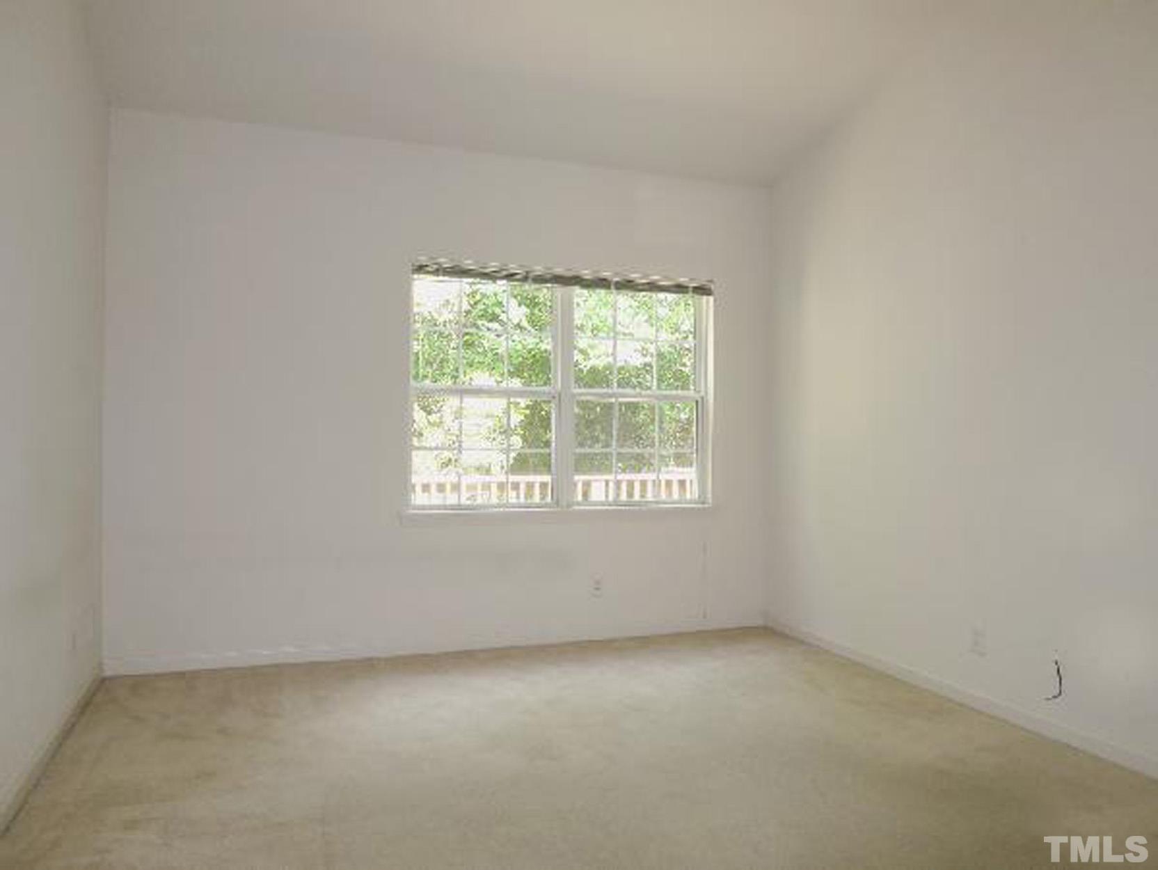 101 Rock Haven Road, Unit A103 Carrboro, NC 27510 - Photo 7 of 17 an empty room with a window