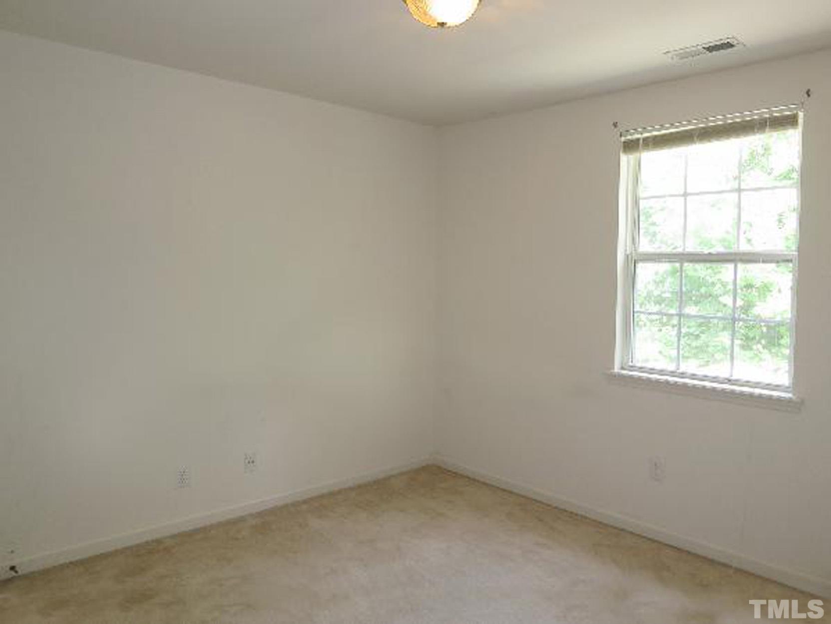 101 Rock Haven Road, Unit A103 Carrboro, NC 27510 - Photo 9 of 17 an empty room with a window