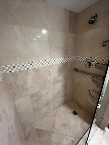 a bathroom with a granite countertop sink a toilet and shower