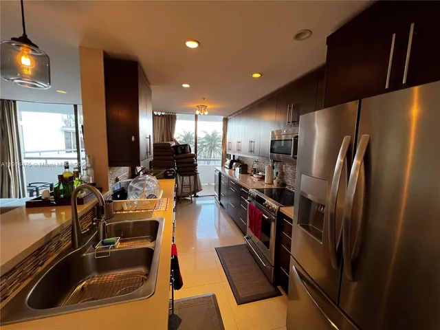 a kitchen with refrigerator and sink