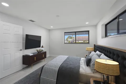 a bedroom with furniture and a flat screen tv