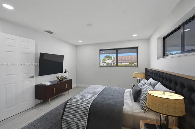 a bedroom with furniture and a flat screen tv