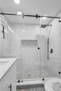 a bathroom with a sink and a shower