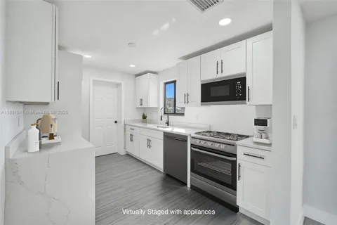 a kitchen with a sink stove and microwave