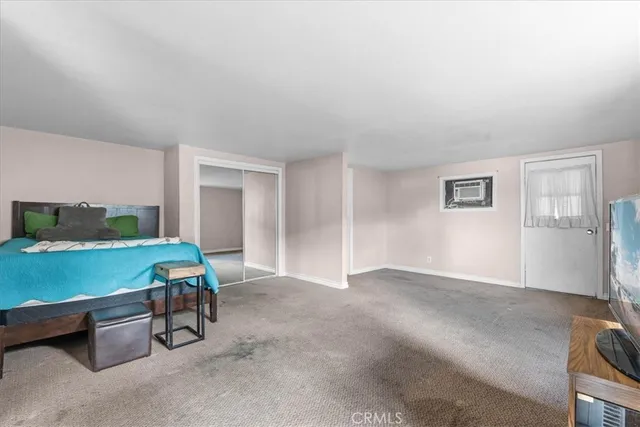 a room with pool table and windows