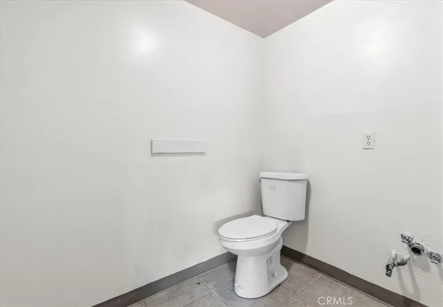 a white toilet sitting next to a white sink