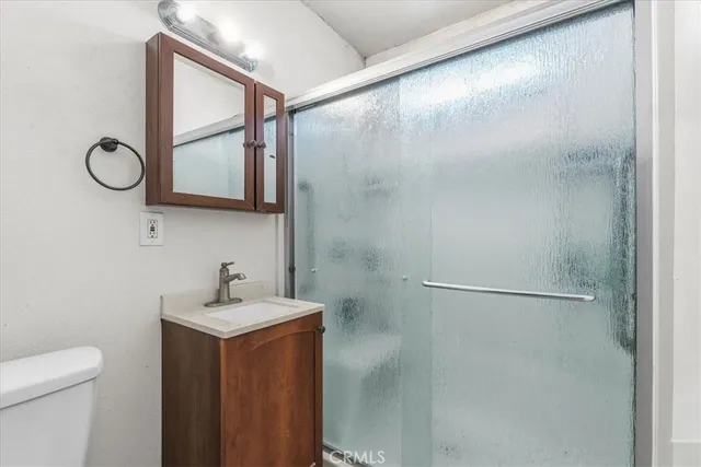 a bathroom with a sink a mirror and a shower