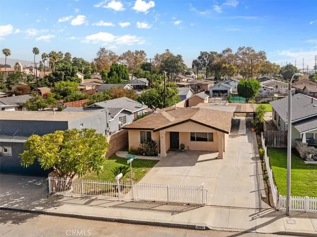 a view of a white house with a yard