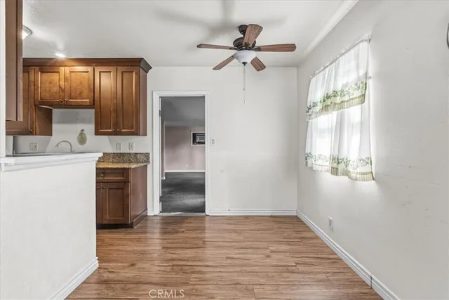 a view of a kitchen with a sink dishwasher and wooden floor