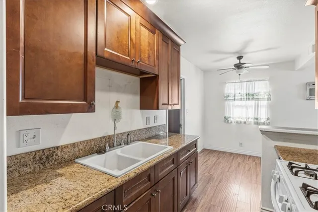a bathroom with a granite countertop sink a vanity and a window