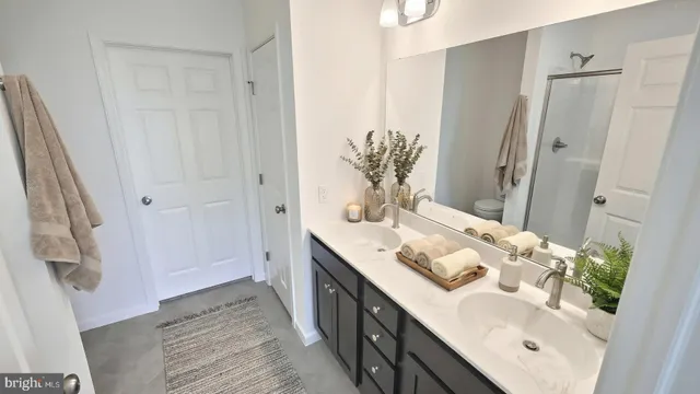 a bathroom with a double vanity sink and mirror
