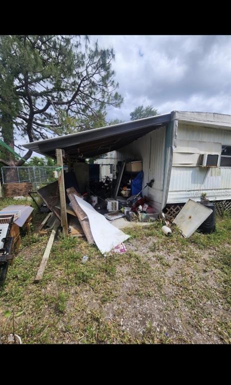 9237 Southeast 58th Drive Okeechobee, FL 34974 - Photo 7 of 15 a view of a wooden house with a bench in it