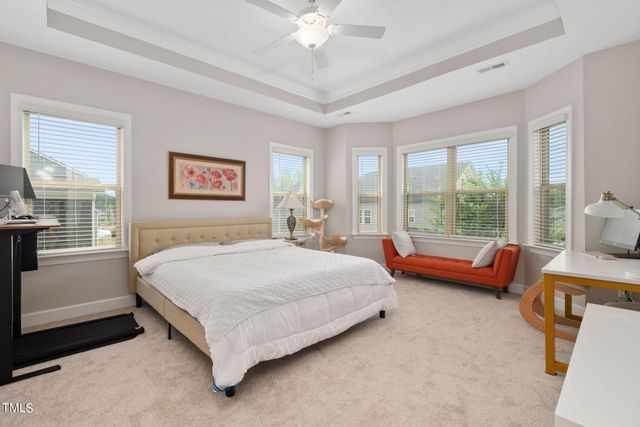 a spacious bedroom with a bed and a large window