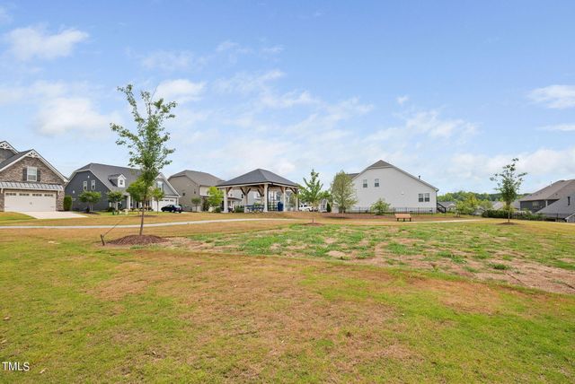 a view of an swimming pool and trees in the background