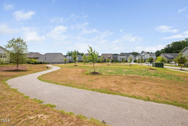 a view of a swimming pool with an outdoor seating and a many windows