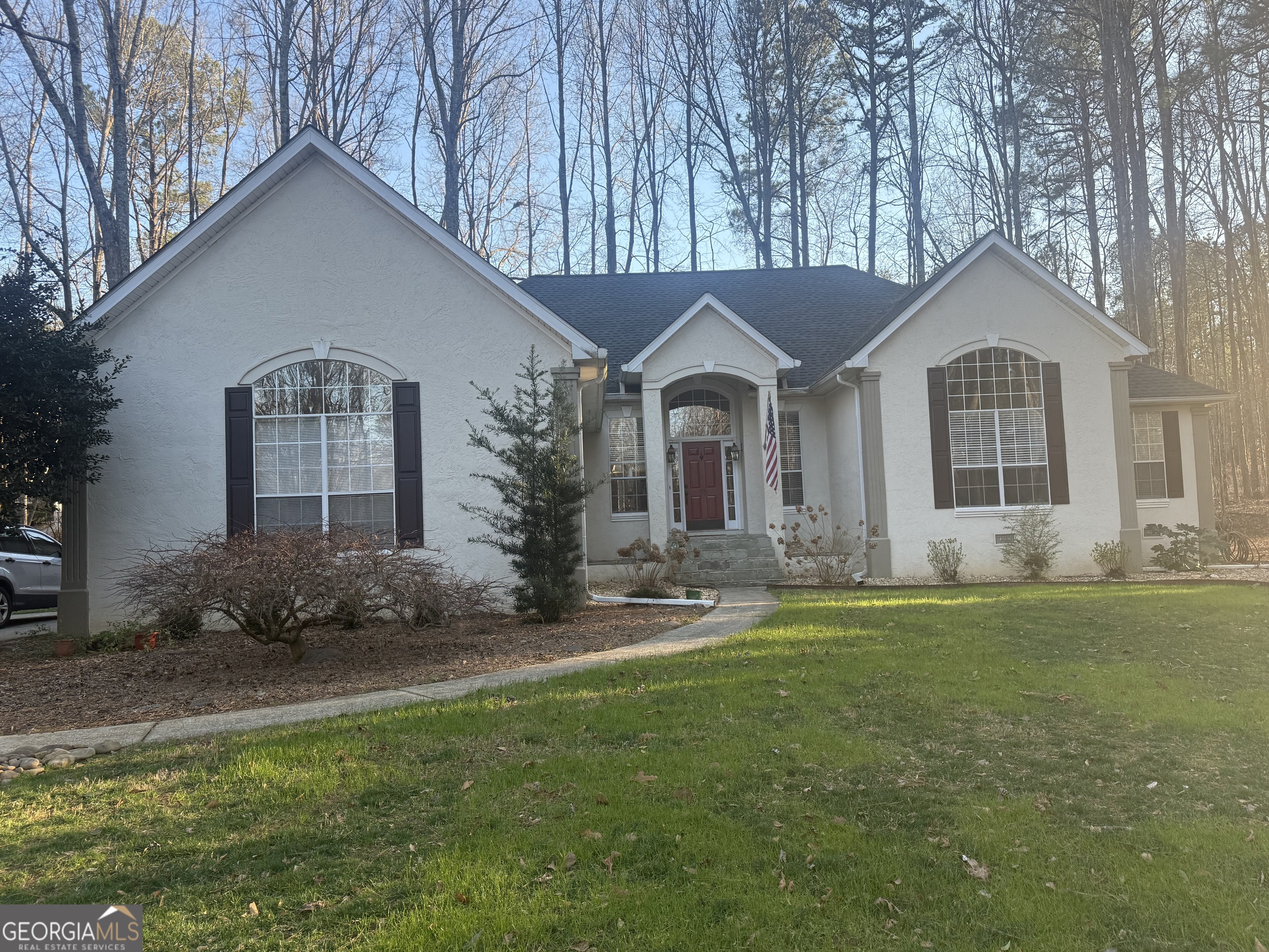 75 Springwater Crossing Newnan, GA 30265 - Photo 1 of 1 a front view of a house with a garden and yard