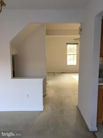 a view of an empty room with chandelier door