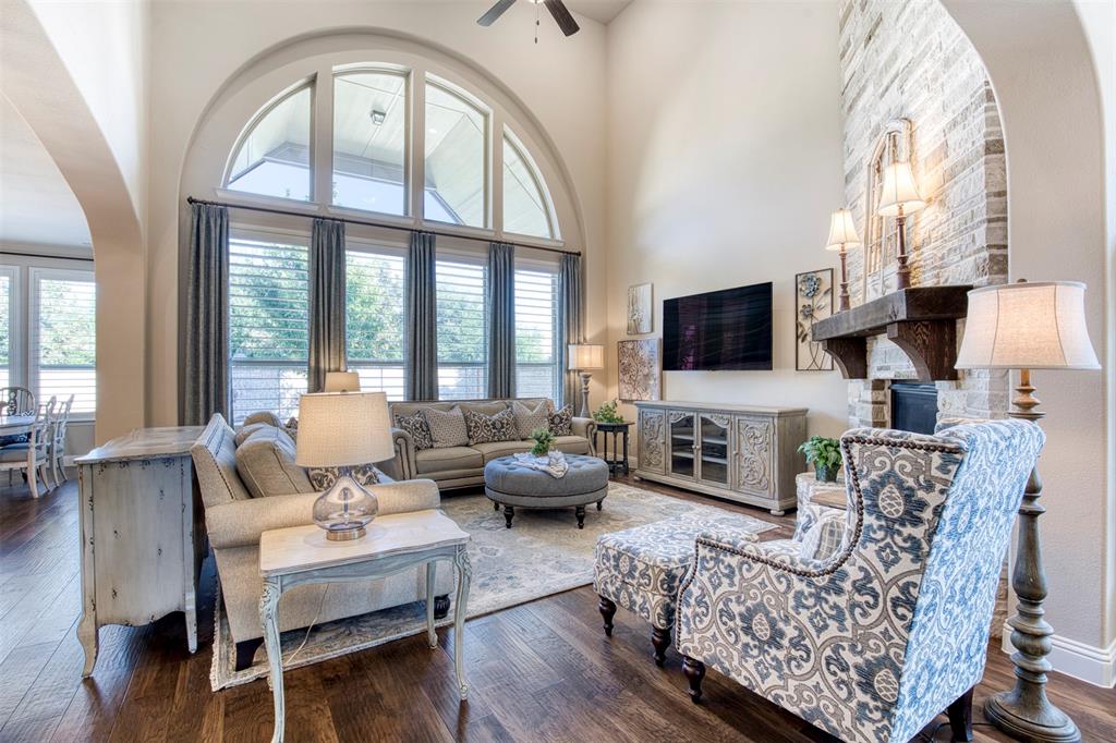 7760 Hackamore Street Frisco, TX 75036 - Photo 6 of 40 Wall of picture windows overlooking the covered patio flood the living room with natural light.