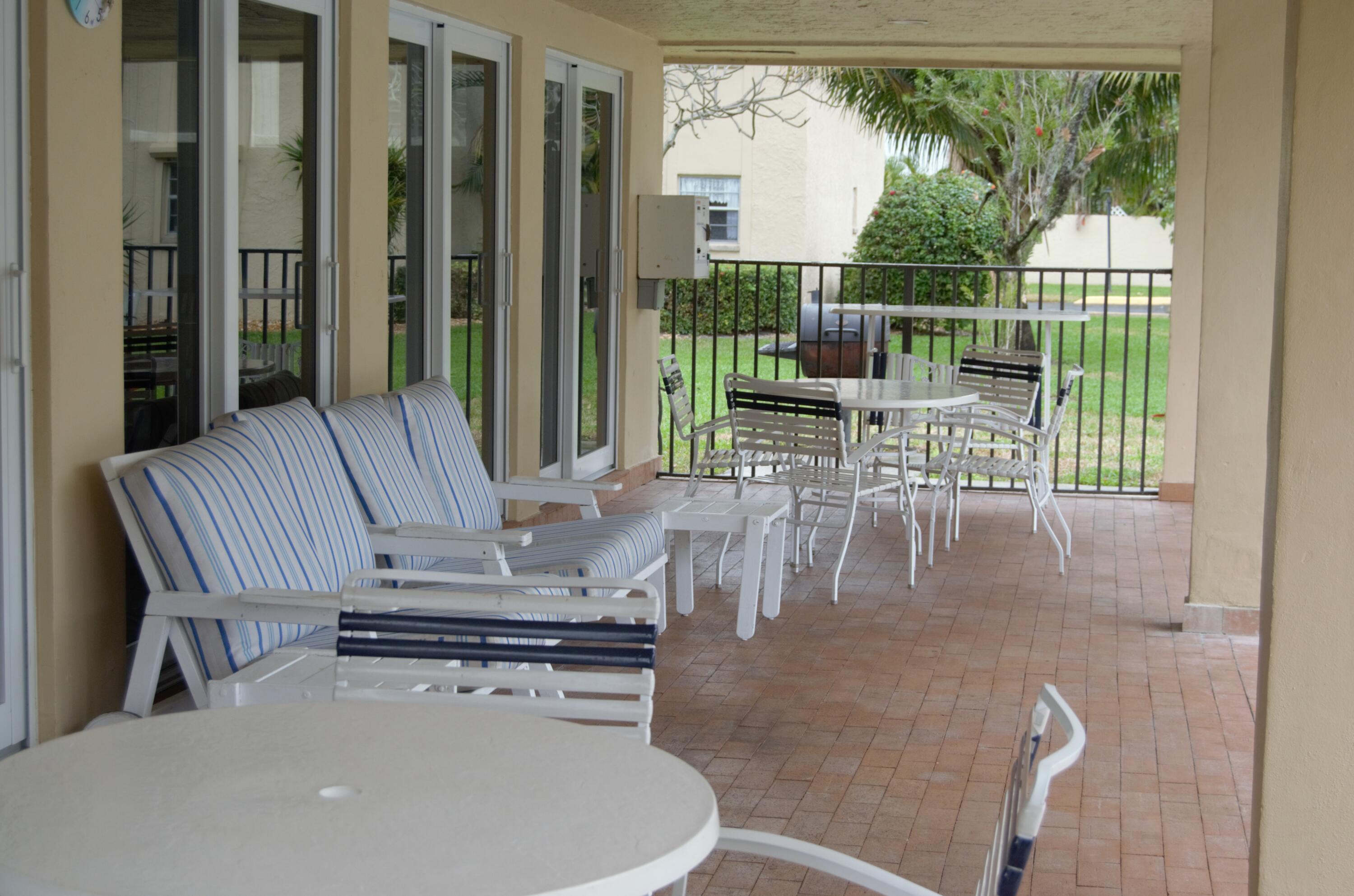 1301 Northwest 12th Avenue, Unit 411A Boca Raton, FL 33486 - Photo 31 of 32 CLUBHOUSE PATIO