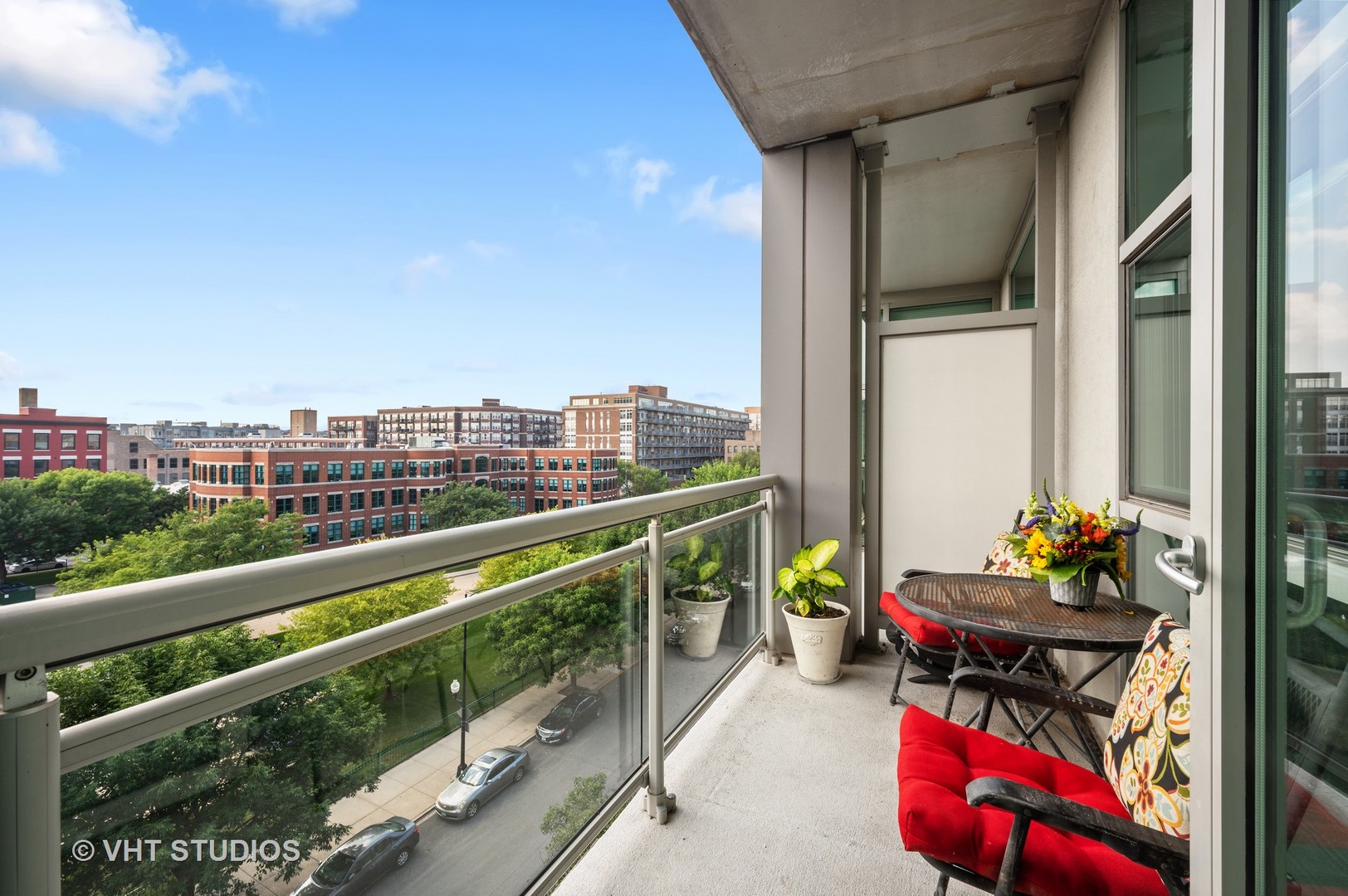 225 South Sangamon Street, Unit 509 Chicago, IL 60607 - Photo 6 of 20 a city view from a balcony with furniture