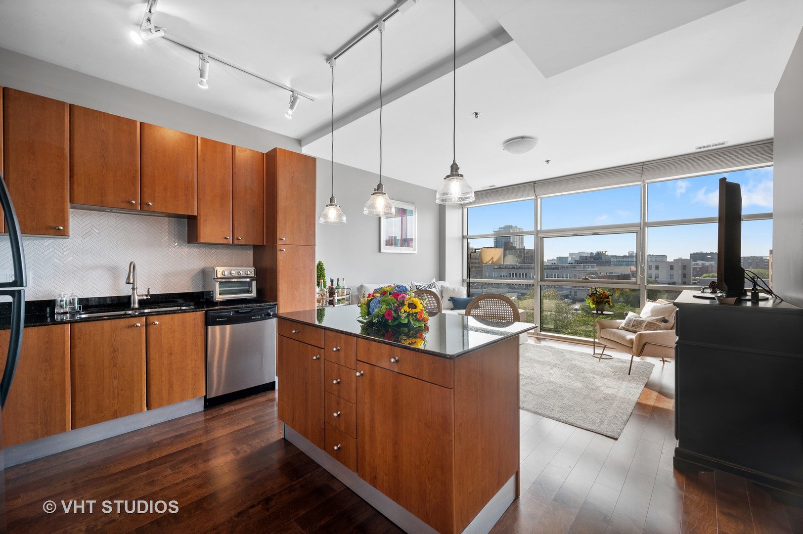225 South Sangamon Street, Unit 509 Chicago, IL 60607 - Photo 8 of 20 a kitchen with stainless steel appliances kitchen island granite countertop a refrigerator a sink and a stove