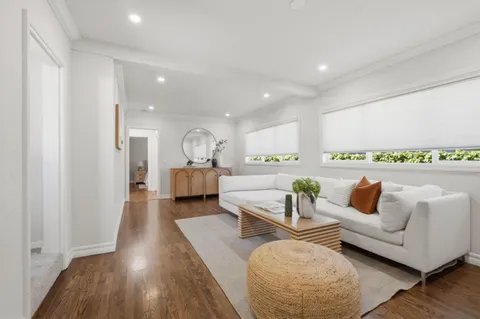 a bathroom with a tub shower sink and mirror