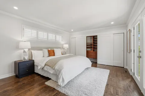 a spacious bedroom with a bed and a couch