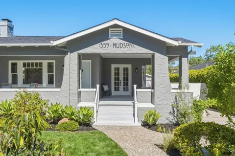 a living room with furniture a large window and a fireplace
