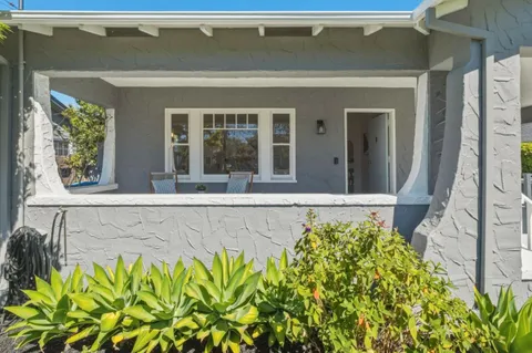 a living room with furniture a large window and a fireplace