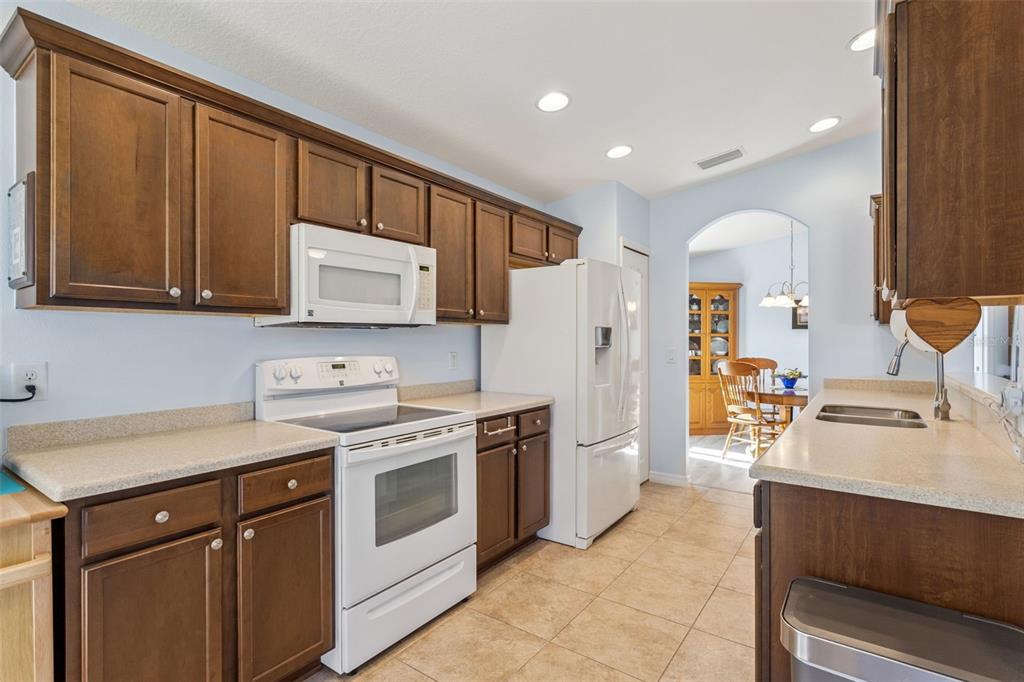 3601 Arlington Ridge Boulevard Leesburg, FL 34748 - Photo 11 of 44 a kitchen with a sink stove and refrigerator