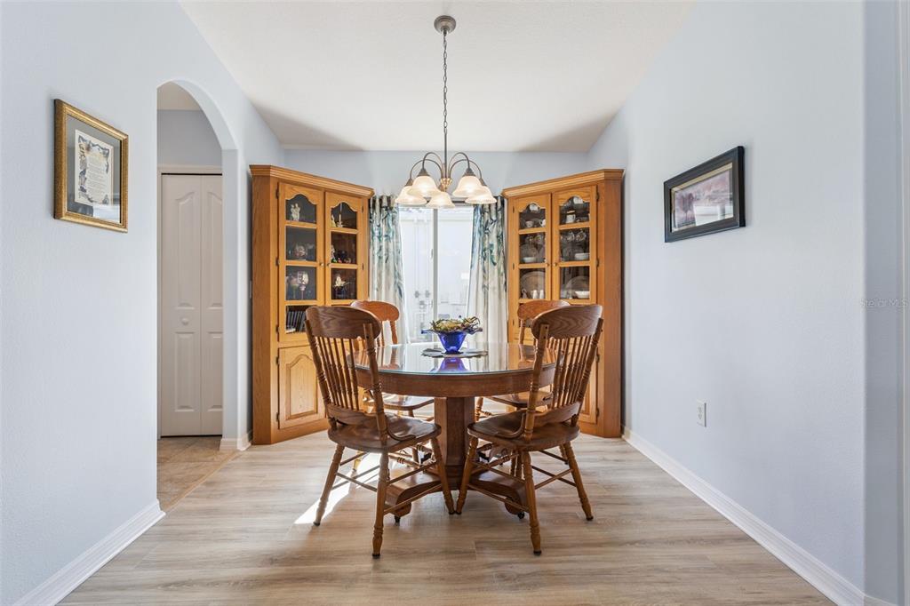 3601 Arlington Ridge Boulevard Leesburg, FL 34748 - Photo 12 of 44 a view of a dining room with furniture window and wooden floor