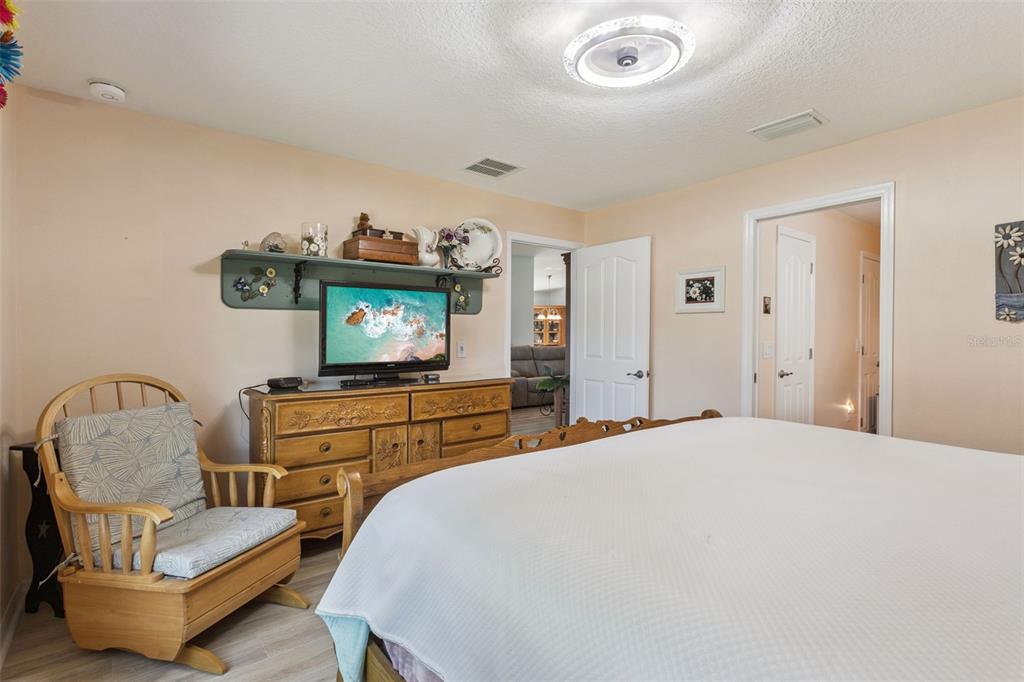 3601 Arlington Ridge Boulevard Leesburg, FL 34748 - Photo 16 of 44 a bedroom with a bed and a chair