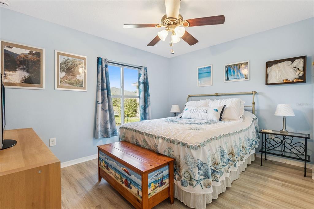 3601 Arlington Ridge Boulevard Leesburg, FL 34748 - Photo 17 of 44 a bedroom with a bed and a chandelier