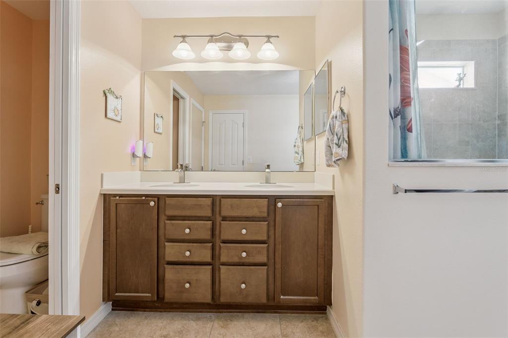 3601 Arlington Ridge Boulevard Leesburg, FL 34748 - Photo 20 of 44 a bathroom with a double vanity sink and a mirror