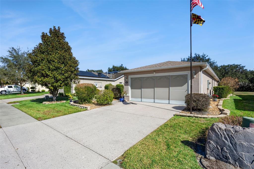 3601 Arlington Ridge Boulevard Leesburg, FL 34748 - Photo 2 of 44 a house view with a garden space