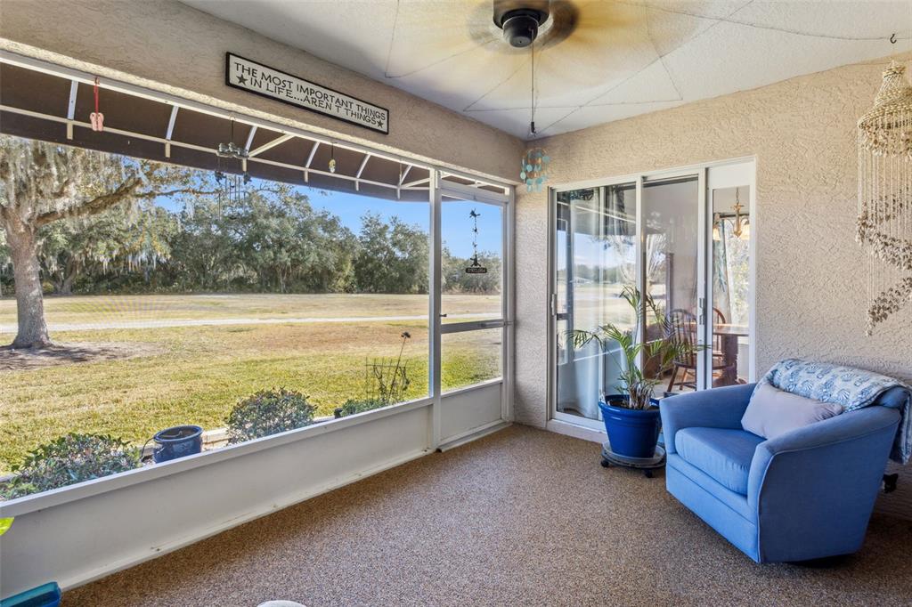 3601 Arlington Ridge Boulevard Leesburg, FL 34748 - Photo 23 of 44 a living room with furniture and a floor to ceiling window