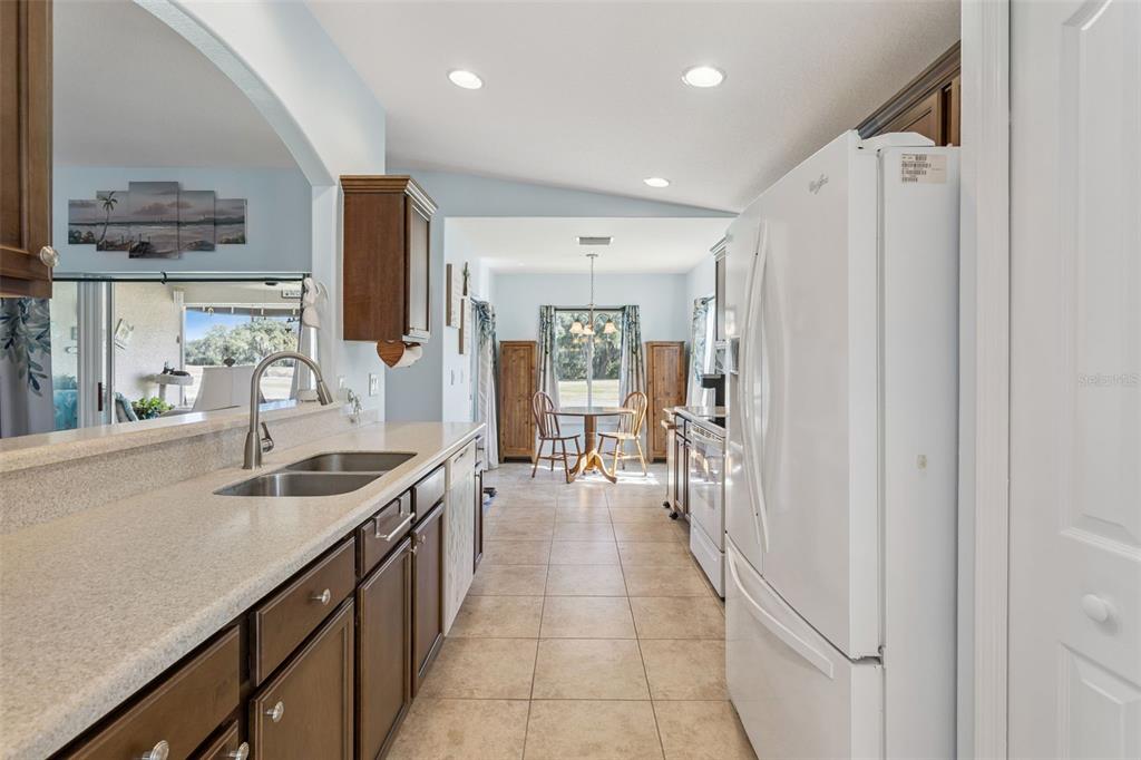 3601 Arlington Ridge Boulevard Leesburg, FL 34748 - Photo 10 of 44 a kitchen with stainless steel appliances granite countertop a sink and a refrigerator