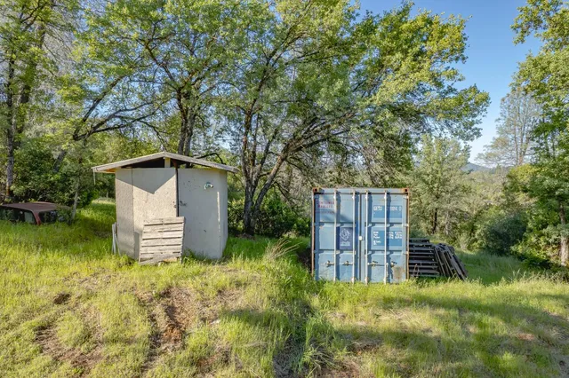 a backyard of a house with lots of green space and lake view